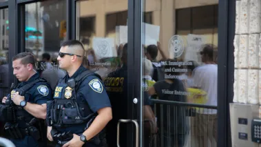 Protesters outside ICE offices, two police officers outside